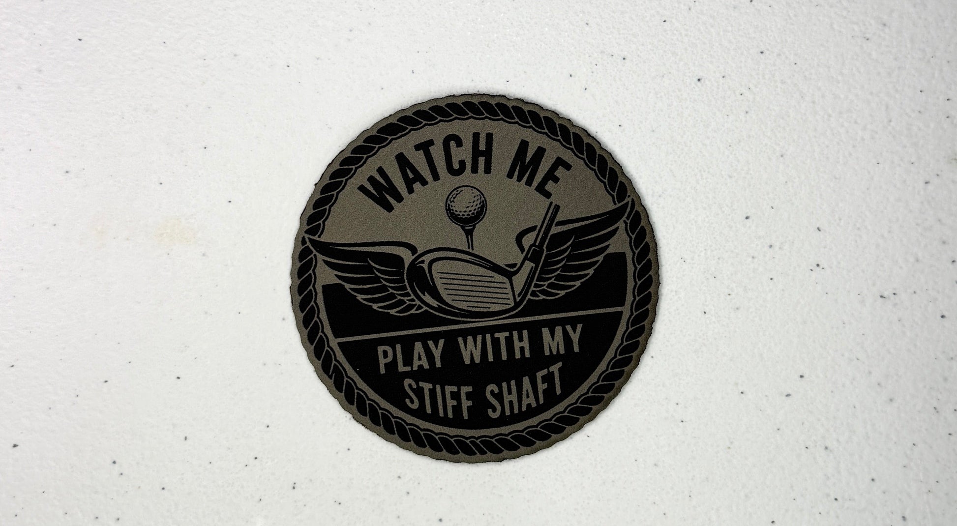 Round black patch with text and graphics on a white background